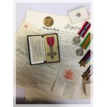 A CASED MBE MEDAL WITH ACCOMPANYING PAPE