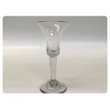 A GEORGIAN PLAIN STEM GLASS ON A DOMED F