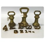 THREE UN-MARKED BRASS BELL WEIGHTS ALONG