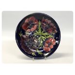 A MOORCROFT PLATE, ANEMONE PATTERN, 26CM