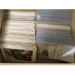 BOX OF MIXED POSTCARDS IN AN ALBUM AND L