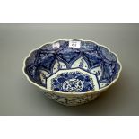A 19th century Chinese porcelain blue and white lotus form bowl, internally decorated with panels of