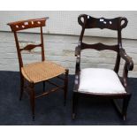 A Victorian mahogany rocking chair with shaped rail and splat, swan mask swept scrolled arms,