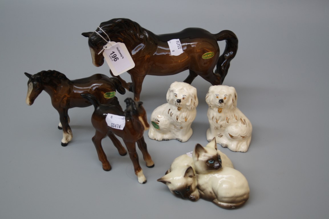 Three Beswick brown gloss horses, a pair of Beswick seated spaniels and a Siamese kitten group