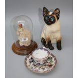 A Kensington pottery model of a seated Siamese cat with turquoise glass eyes, a pair of early 20th