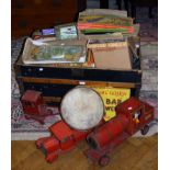 A 19th century dome top trunk containing a collection of largely mid 20th toys and juvenalia