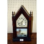 A late 19th century American mantel clock, the gothic rosewood case enclosing a day going