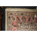 A 20th century Indian wool carpet, woven with a stepped central lozenge medallion within a