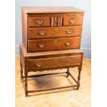 A late 18th century East Anglian oak chest on stand, the moulded edge top over serpentine frieze,