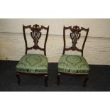 A pair of Edwardian walnut nursing parlour chairs, each with leaf carved shaped rail and splat ,