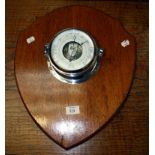 An F C C chrome cased ship's barometer, 18cm diameter, mounted upon an oak shield