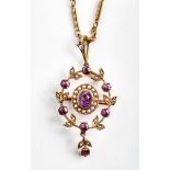 An Edwardian amethyst and seed pearl brooch/pendant, with central oval cut amethyst within a