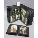 Two early 20th century post card albums, containing many dozens of cards, including naval and