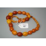 A graduated vari coloured amber bead necklace, composed of polished oval beads, length 70cm