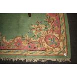 A 20th century Chinese wool carpet, woven with a central oval floral reserve within a conforming
