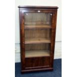 A late 19th century mahogany bookcase, the moulded edge top over a glazed and panel door enclosing