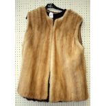 Two ladies three quarter length fur waistcoats