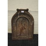 A small cast iron bedroom fire back of arched form decorated with an Edwardian tennis player, 57 x
