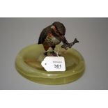 An early 20th century cold painted bronze Kingfisher, modelled with catch, on a dished onyx base, 11