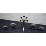 A contemporary burnished wrought iron four sconce candle stand with swept branches, 36 x 101cm