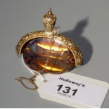 A large three faced citrine swivel seal, in foliate pendant mount