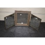 An early 20th century three glass folding toilet mirror, the reverse with fabric panels painted with