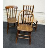 Two 19th century elm stick back dining chairs together with a single rush seat spindle back dining