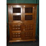 A 20th century Portuguese hutch cupboard having a pair of spindle doors above a pair of fielded