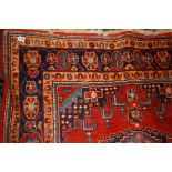 A 20th century Hamadan rug, woven with stepped central and other lozenge medallions within floral