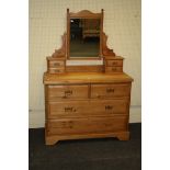 An Edwardian pine dressing chest, the adjustable mirror over two pairs of trinket drawers, the