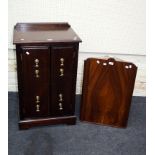 A mahogany veneered two door cupboard with heavy brass axe drop handles together with a 1930's