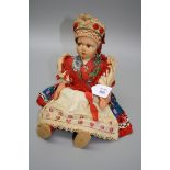 A mid 20th century Lenci-type pressed felt doll, with brown painted side glancing eyes, jointed