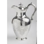 A Victorian wine jug, inverted pear-shape with profuse acanthus scroll engraving around four oval