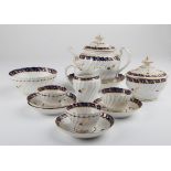 An 18th century Worcester porcelain tea service, of wrythen form, comprising tea pot and stand,