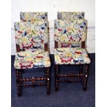 A set of four early 20th century oak dining chairs, each with brass studded woolwork upholstery on