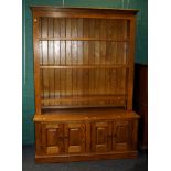 A contemporary oak library bookcase, the moulded cornice over three adjustable shelves, the base