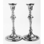 A pair of late 19th century George III Adam style candlesticks, knopped tapering stems, urn-shaped