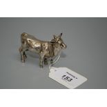 An Edwardian silver snuff box in the form of a bull, realistically modelled with collar and bell