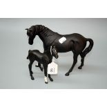 A Beswick black matt glazed horse and foal