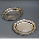 A pair of Georgian III meat dishes, shaped oval form, with gadrooned borders and armorial engravings