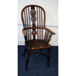 A 19th century elm double hoop and stick back Windsor chair with pierced splat, saddle seat, on