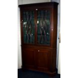 A 19th century mahogany floor standing corner cupboard, the moulded dentil cornice over blind fret