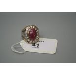 An American Fraternity ring, set with a large cabochon ruby within a bi-coloured engraved mount,