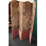 A Victorian four panel dressing screen, later upholstered in loom woven Flemish tapestry and