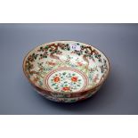 A 19th century Chinese Famille Verte bowl, internally decorated with flowering trees, the exterior