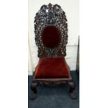 A 19th century Anglo-Indian carved padouk hall chair, the floral open work high back with plush