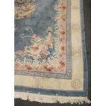 A contemporary Chinese sculpted and super washed carpet, with blue ground, pearl and dragon motif