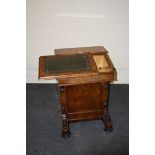 A Victorian figured walnut Davenport writing desk, with unusual side sliding writing surface, the