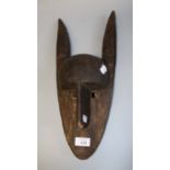 A carved wood African 'Dogon' mask of fox form, 47cm long