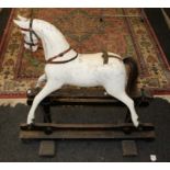 An early 20th century carved and painted rocking horse, of small proportions